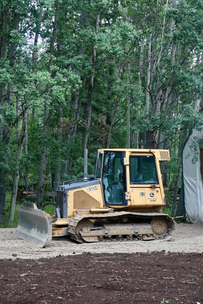 Skid steer preparing land for custom home sites reno project